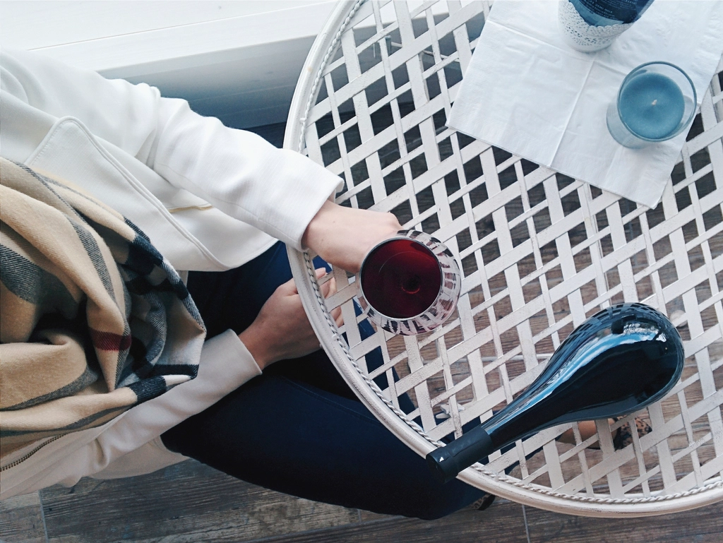 Woman having glass red wine